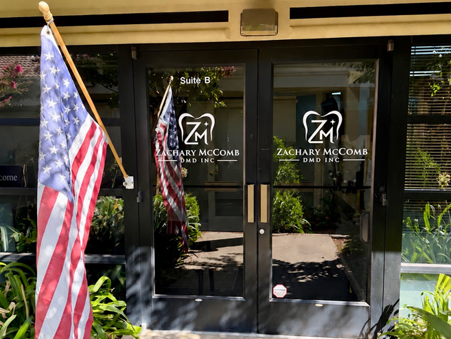 dr mccomb entrance doors with logo and flag